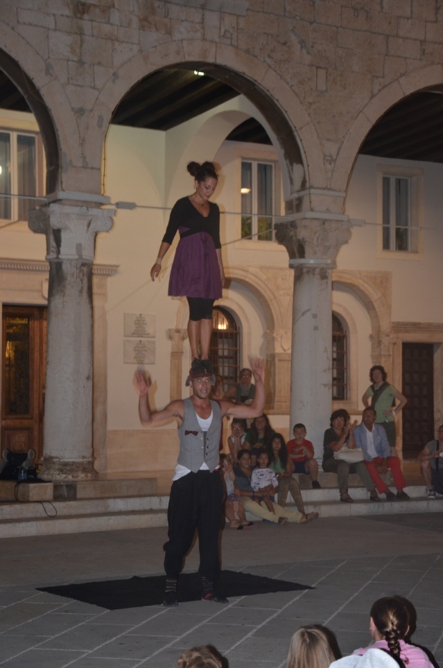 Daring performance by street artistes outside forum, Pula.