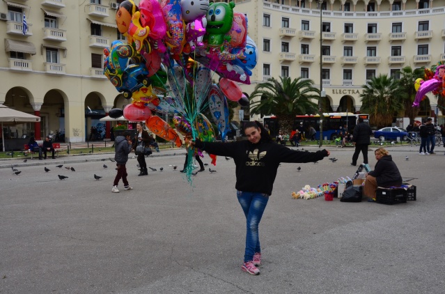 Teenage girl selling helium balloons on Independence Day in Thessaloniki, Greece.