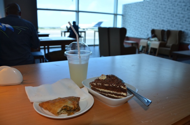 My breakfast of a camel meat samosa, white forest cake and lemonade at the lounge, Mogadishu Airport